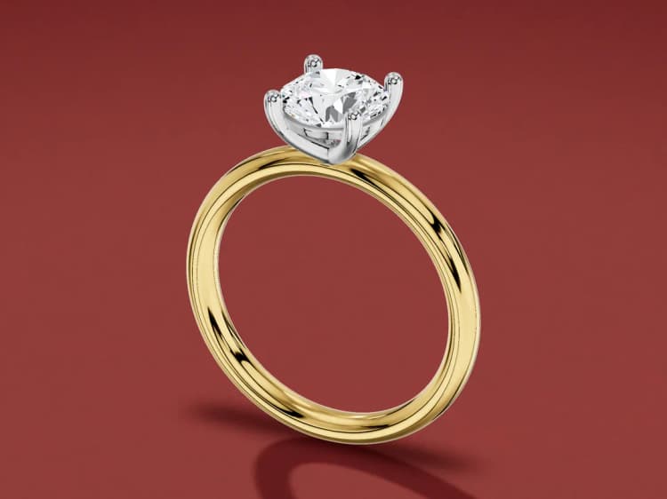 3D render of a round solitaire with a white gold head and claws on a yellow gold band