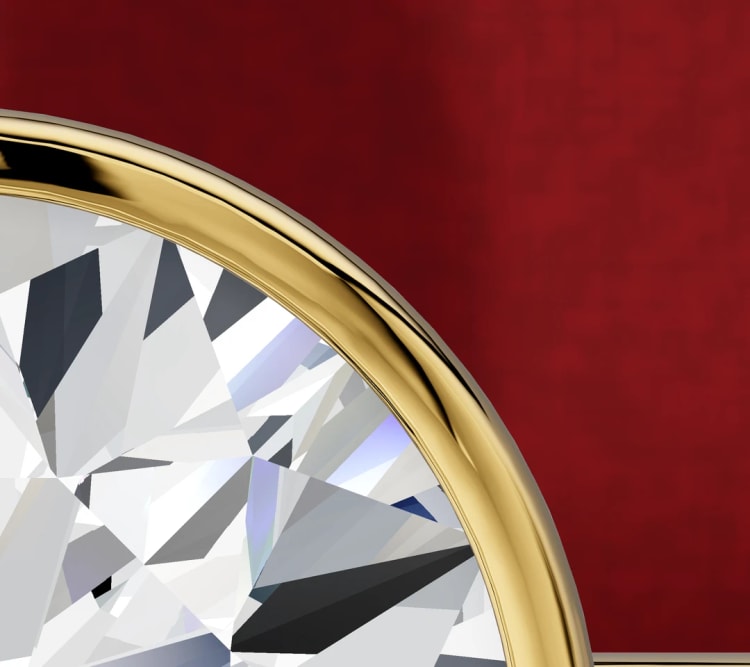 Close-up of a yellow gold bezel rim around the edge of a round diamond, by Lily Dia Jewellery
