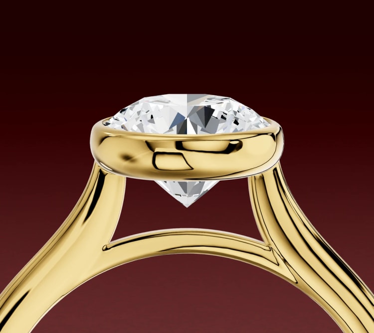 Side view of a round diamond bezel setting, with the rim around the stone and open space beneath it, by Lily Dia Jewellery