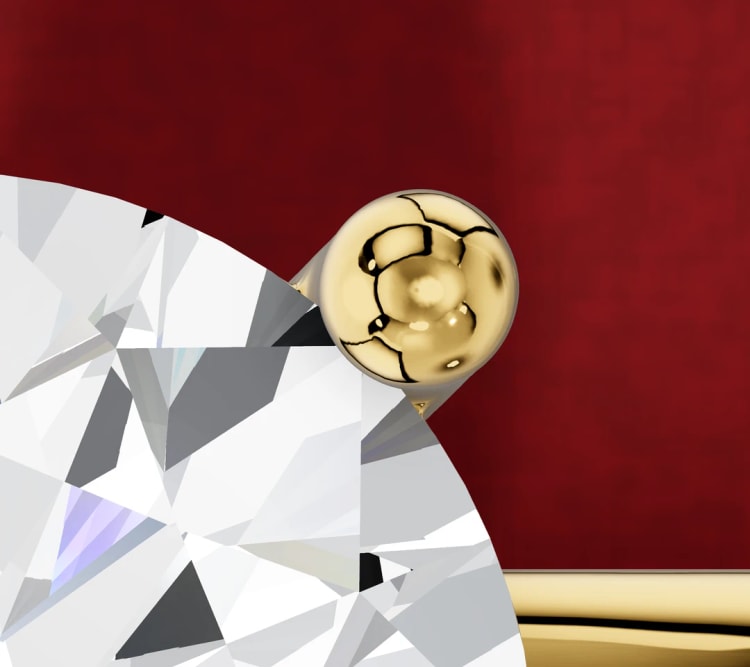 Close-up of a yellow gold claw tip holding the edge of a round diamond, by Lily Dia Jewellery