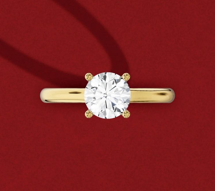 Round diamond solitaire engagement ring seen from above, showing the band outline and four claws, by Lily Dia Jewellery