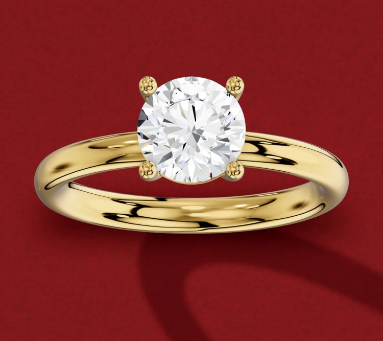 Straight shank round diamond solitaire with an even yellow gold band, seen from slightly above, by Lily Dia Jewellery