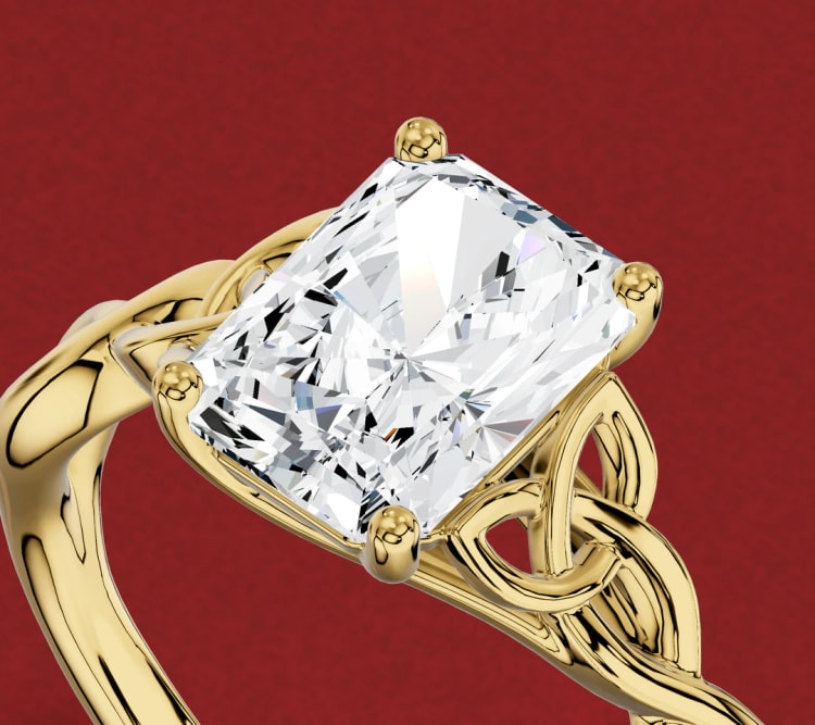 Radiant cut diamond engagement ring in yellow gold with four claws and a woven band, seen at an angle, by Lily Dia Jewellery