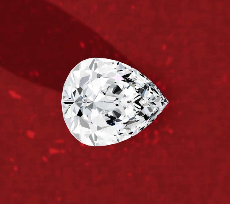 Pear side stone diamond seen face up on its own, its point facing towards the band, by Lily Dia Jewellery