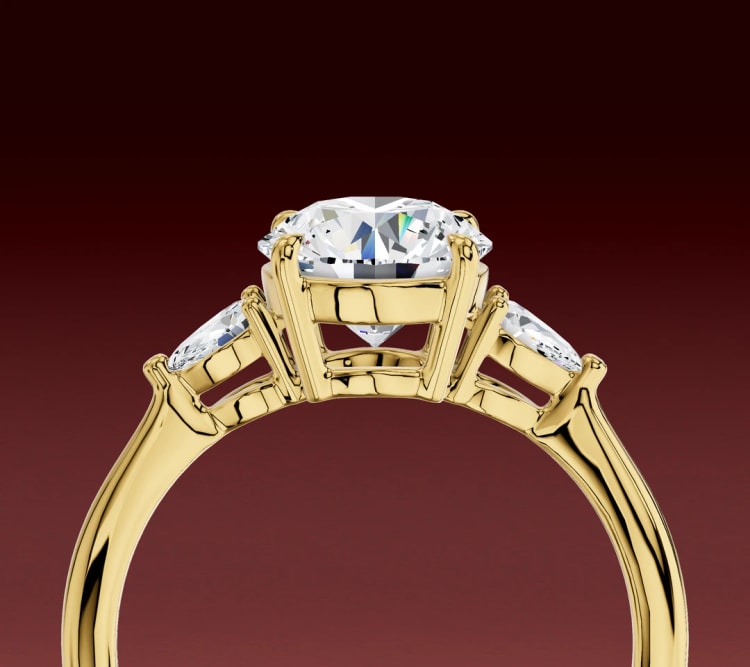 Side view of the pear side-stone three-stone ring, showing how the side stones sit and tilt, by Lily Dia Jewellery
