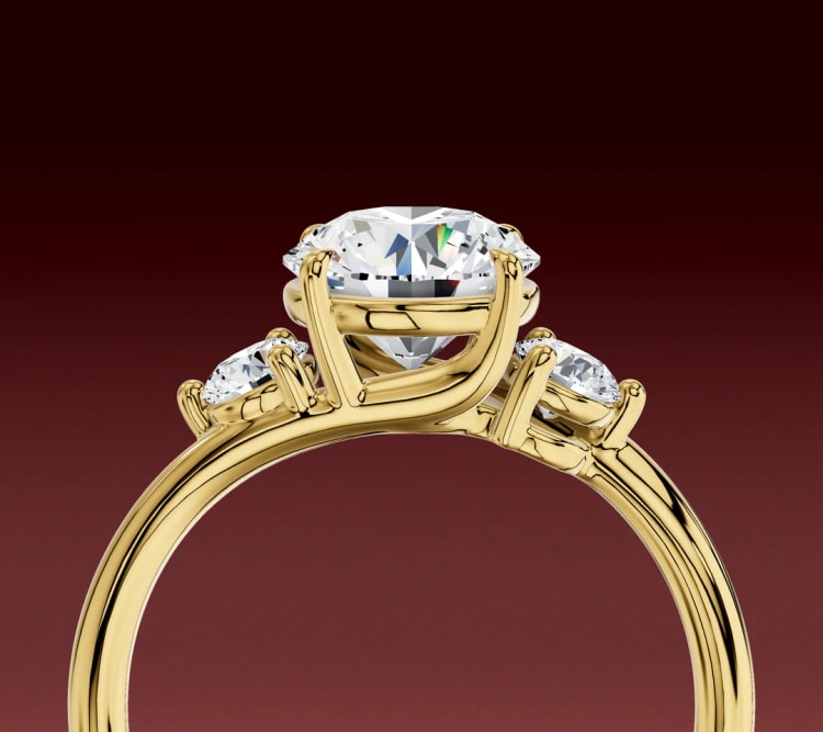 Side view of the round side-stone three-stone ring, showing how the side stones sit and tilt, by Lily Dia Jewellery