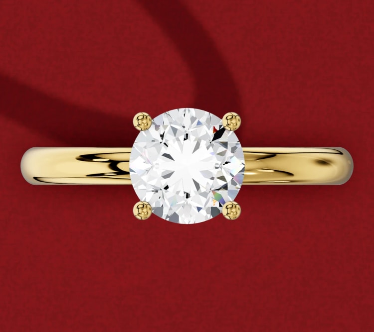 Hidden halo round diamond engagement ring in yellow gold, which looks like a solitaire from above, by Lily Dia Jewellery