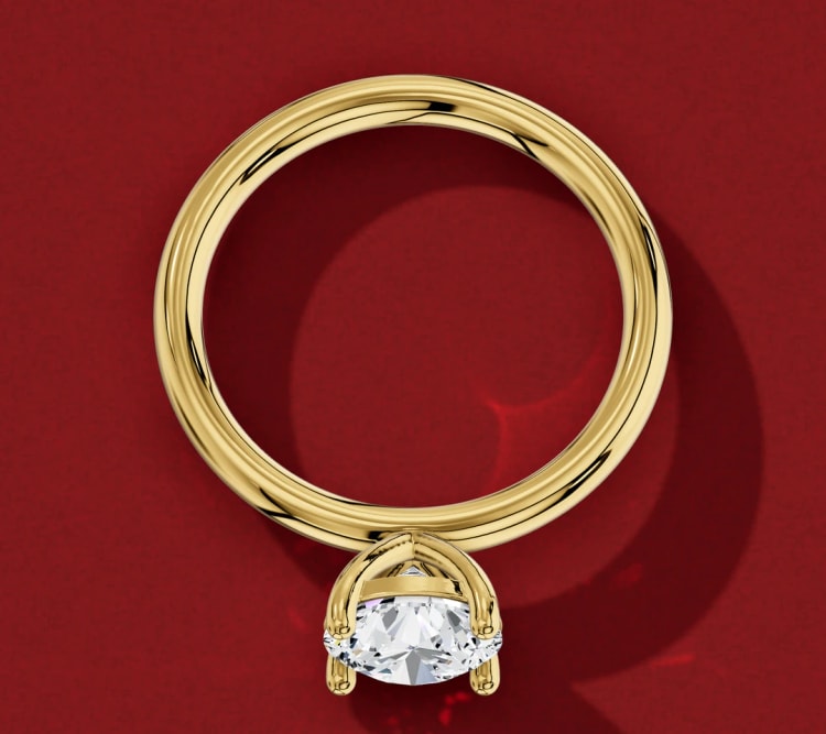 Straight shank round diamond solitaire laid flat, showing the plain yellow gold band all the way round, by Lily Dia Jewellery