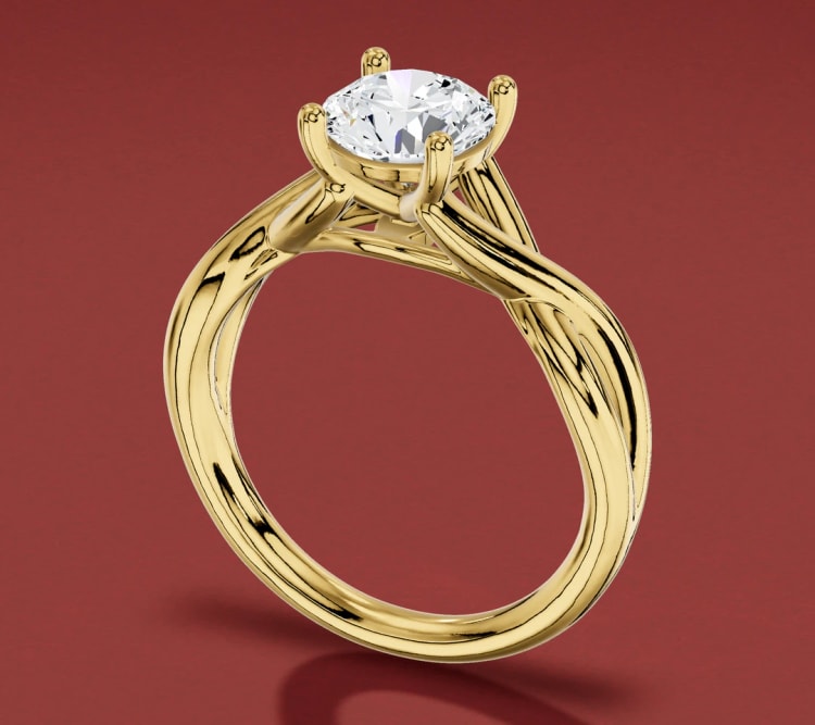 Twisted shank round diamond solitaire engagement ring in yellow gold, seen at an angle, by Lily Dia Jewellery