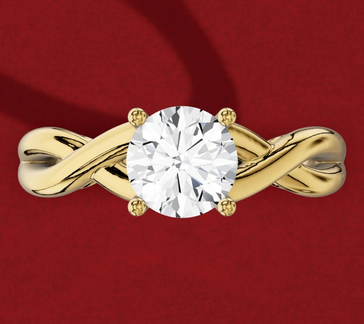 Twisted shank round diamond solitaire, with two strands of yellow gold crossing beside the four-claw head, by Lily Dia Jewellery