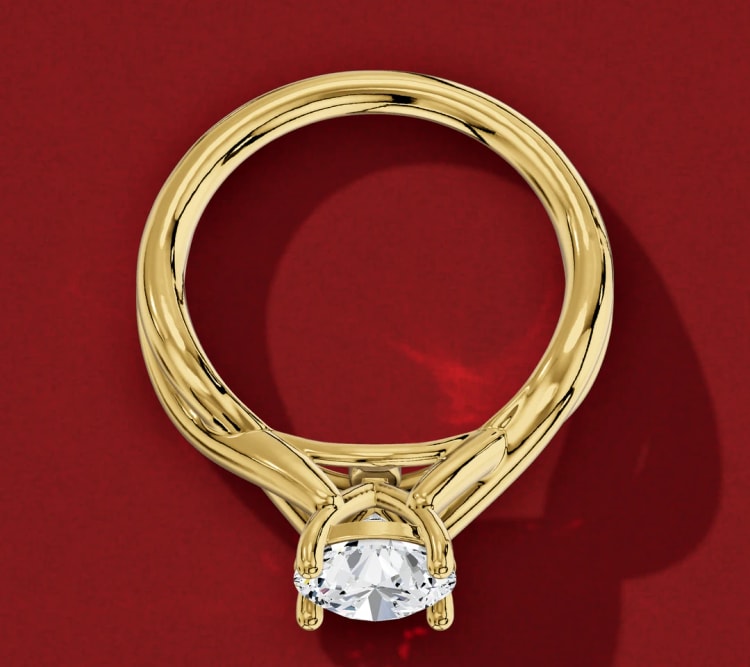 Twisted shank round diamond solitaire laid flat, with the twist near the head and a plain band underneath, by Lily Dia Jewellery