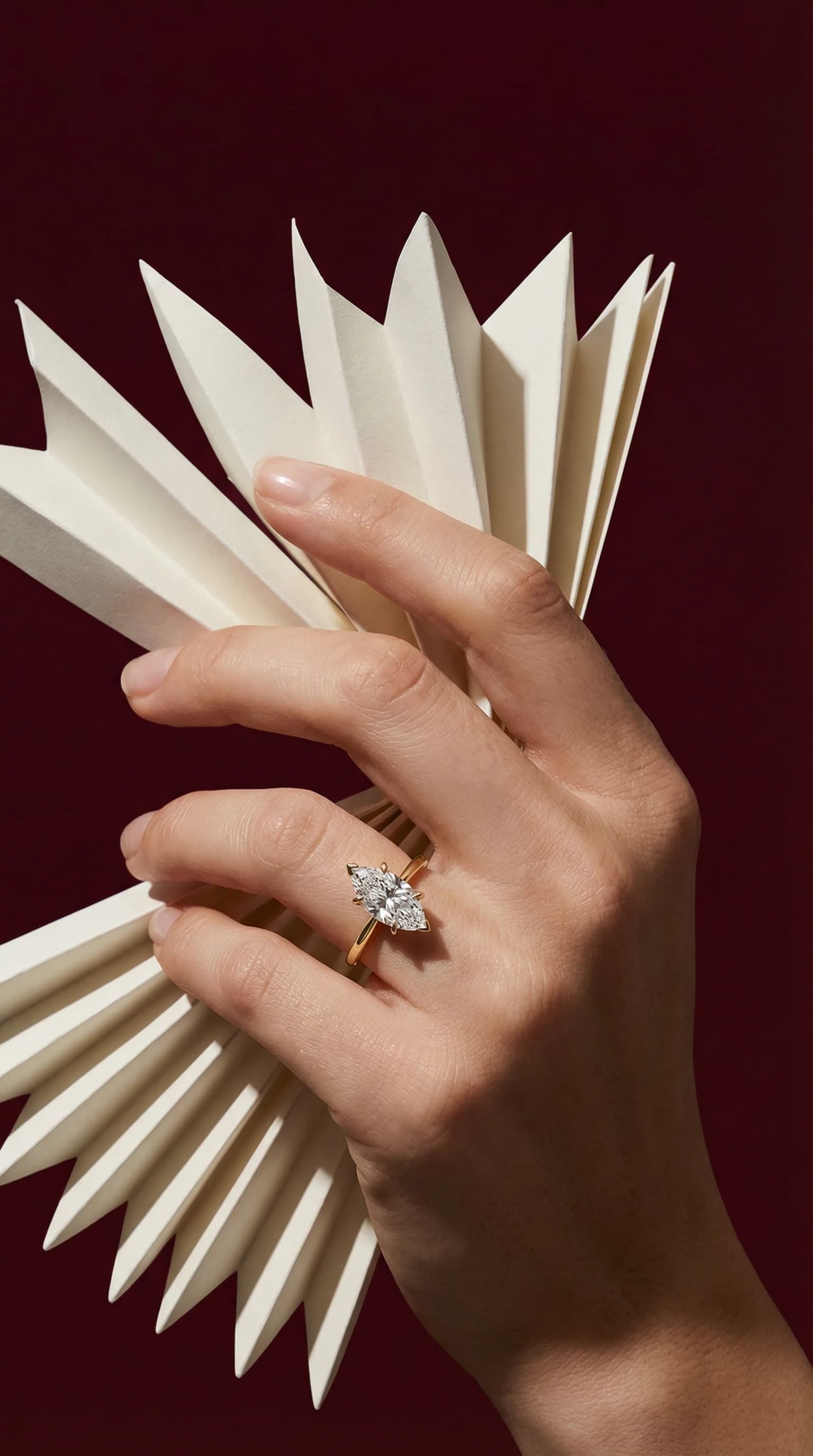 A marquise cut diamond solitaire engagement ring worn on the hand, a marquise cut diamond shape education guide by Lily Dia Jewellery