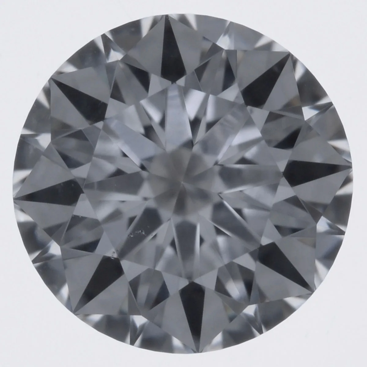 A loose round brilliant cut diamond shown from above, its circular 57 facet brilliant pattern catching the light, a round diamond shape education guide by Lily Dia Jewellery