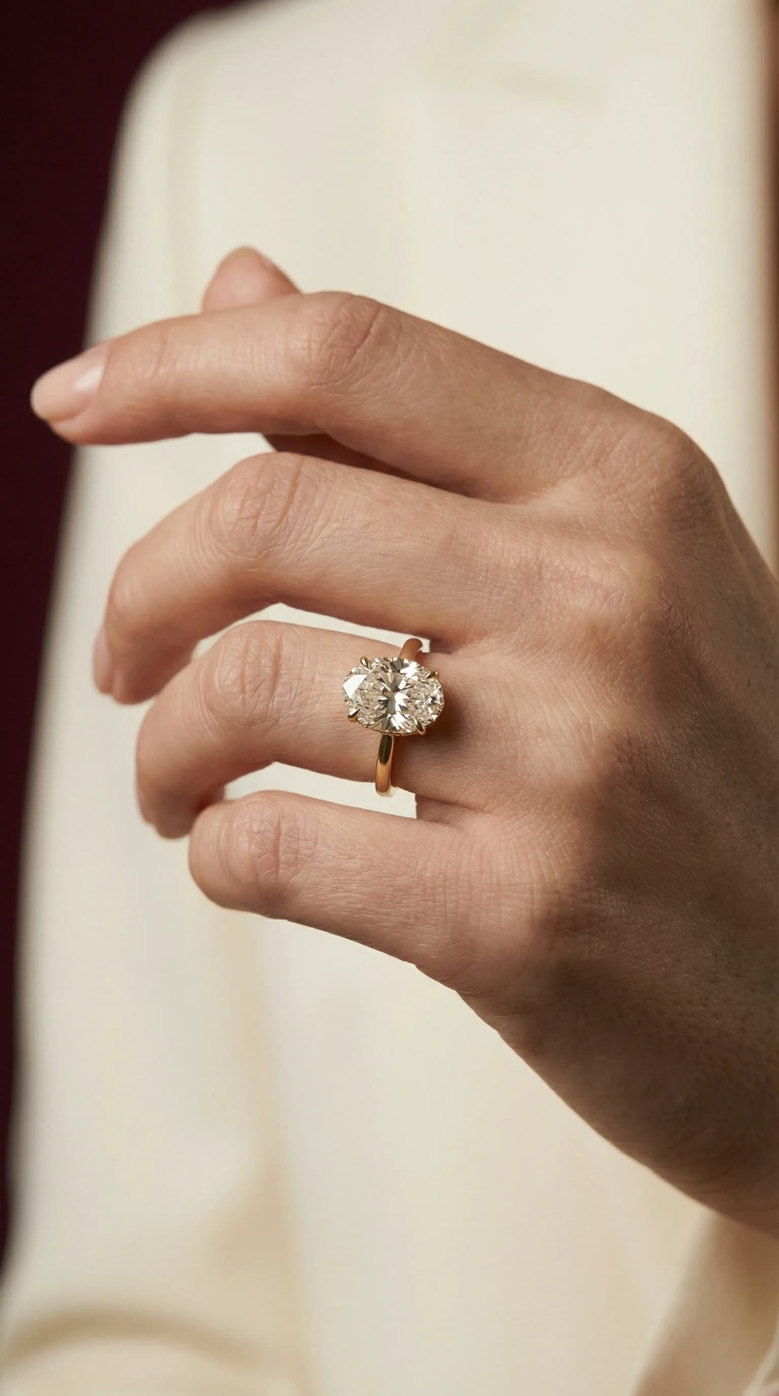 An oval diamond solitaire engagement ring worn on the hand, a solitaire engagement ring style guide by Lily Dia Jewellery