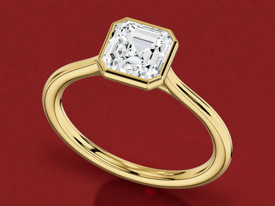 3D render of an Asscher-cut diamond in a yellow gold bezel setting.