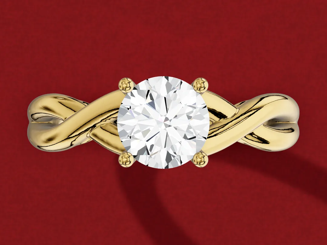 3D render from above of a yellow gold round solitaire whose band splits into two strands that wind over each other on each side.