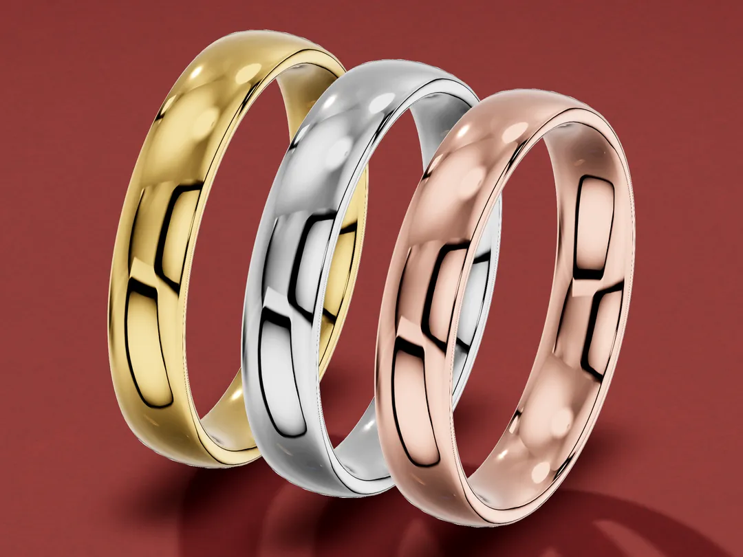 3D render of three matching plain wedding bands standing in a row on a burgundy table, in yellow, white and rose gold.