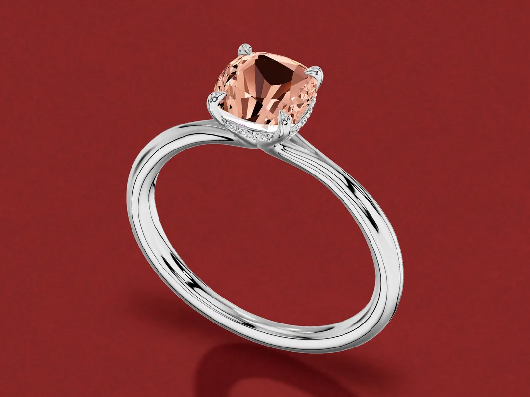 3D render of a cushion-cut pinkish orange padparadscha sapphire in a white gold solitaire with a hidden halo.