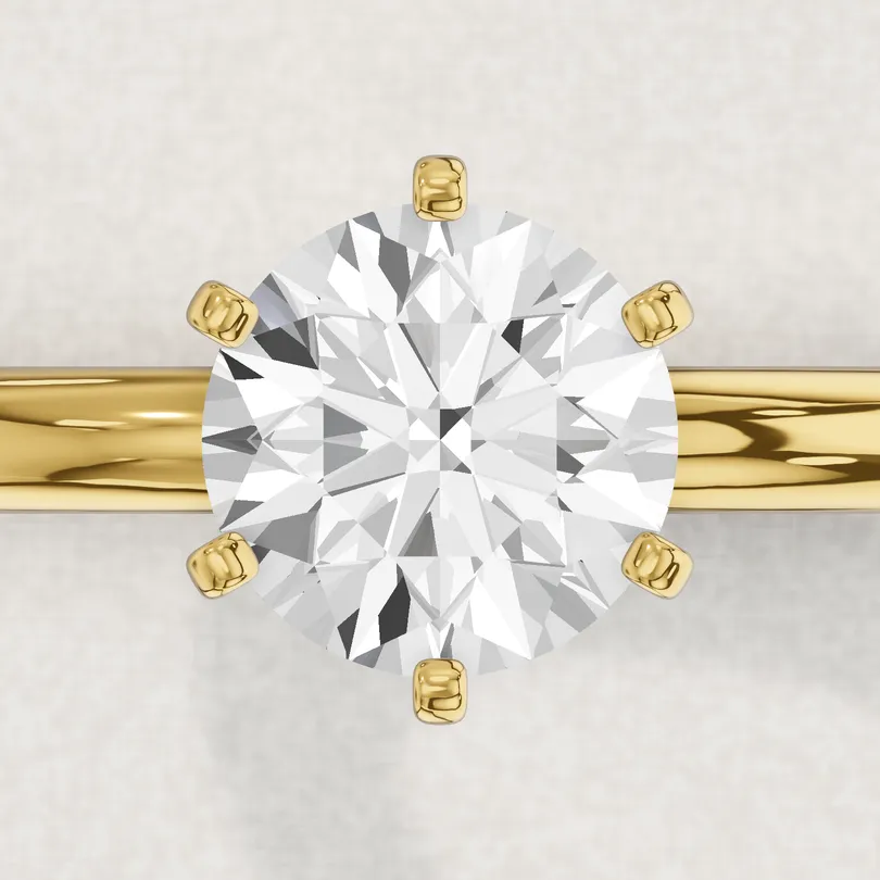 3D render of a 1 carat round diamond held by six yellow gold prongs, seen from above