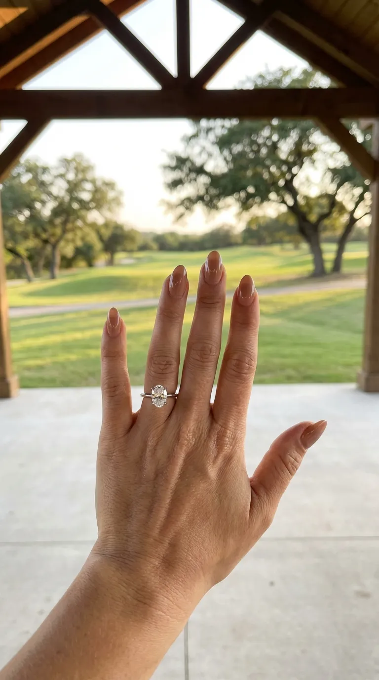 Oval solitaire engagement ring on long slim fingers by Lily Dia Jewellery