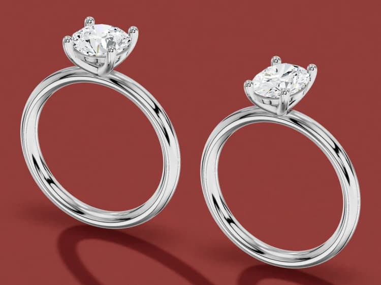 3D render of a plain round solitaire and a plain oval solitaire in white gold, side by side