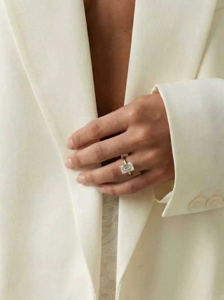 Emerald cut solitaire engagement ring on hand by Lily Dia Jewellery