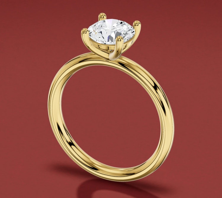 Single shank round diamond solitaire engagement ring in yellow gold, seen at an angle, by Lily Dia Jewellery