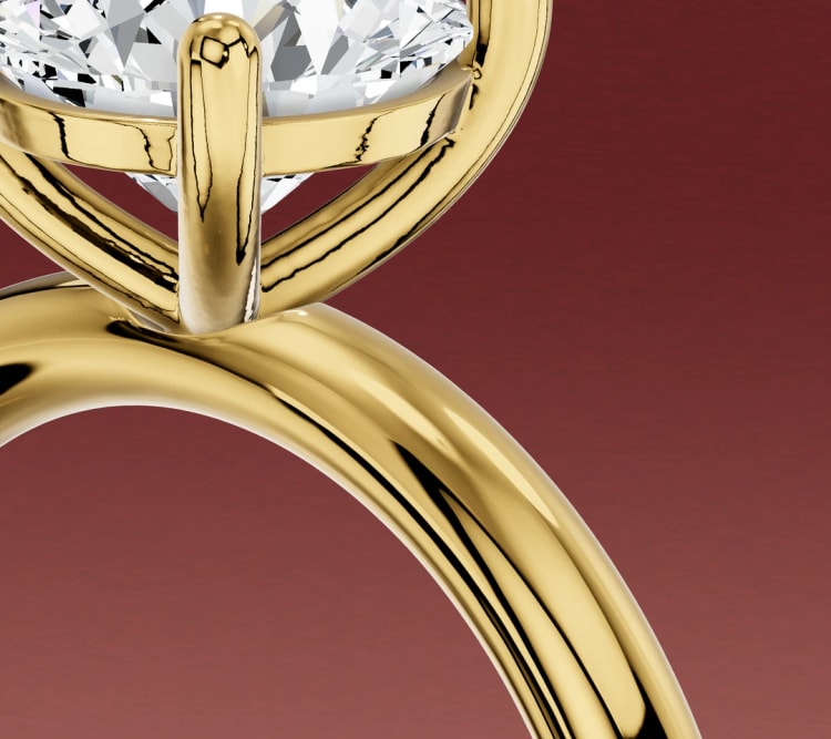 Close-up of a single shank solitaire, with one continuous shoulder meeting the four-claw head, by Lily Dia Jewellery