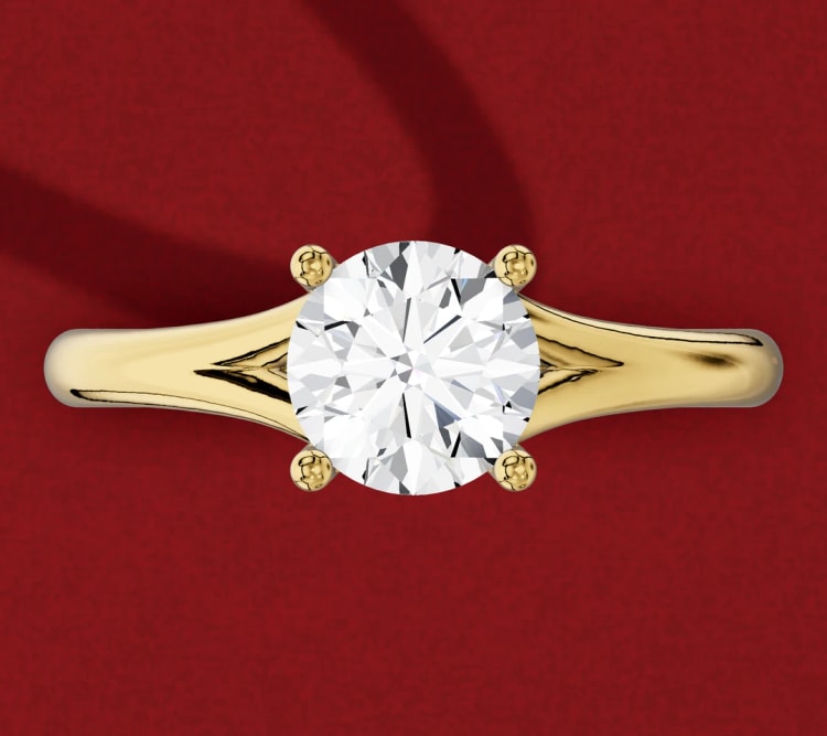 Split shank round diamond solitaire, with the yellow gold band dividing into two arms beside the head, by Lily Dia Jewellery