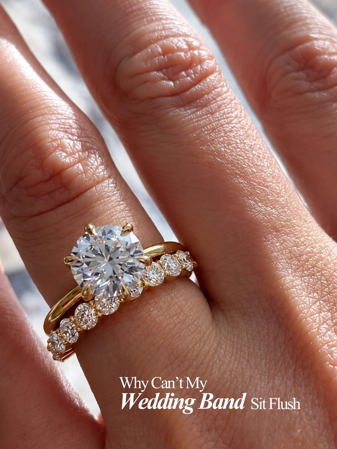 Round diamond engagement ring with a matching diamond wedding band on a hand
