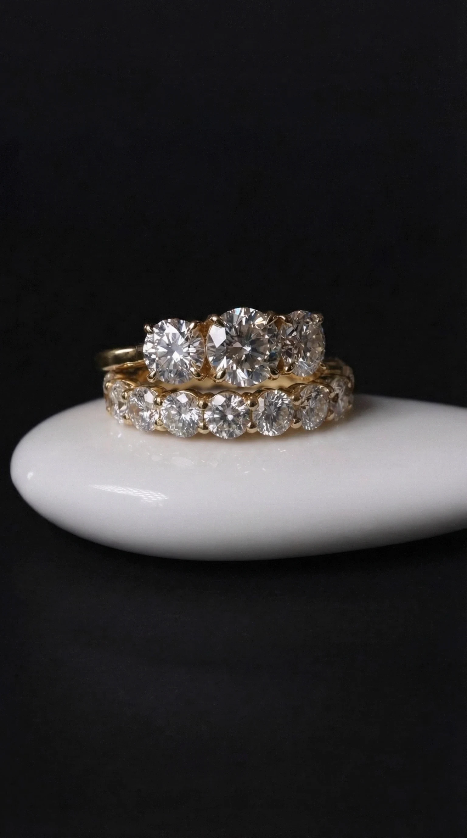 LILY DIA three-stone round diamond ring above a round diamond eternity band