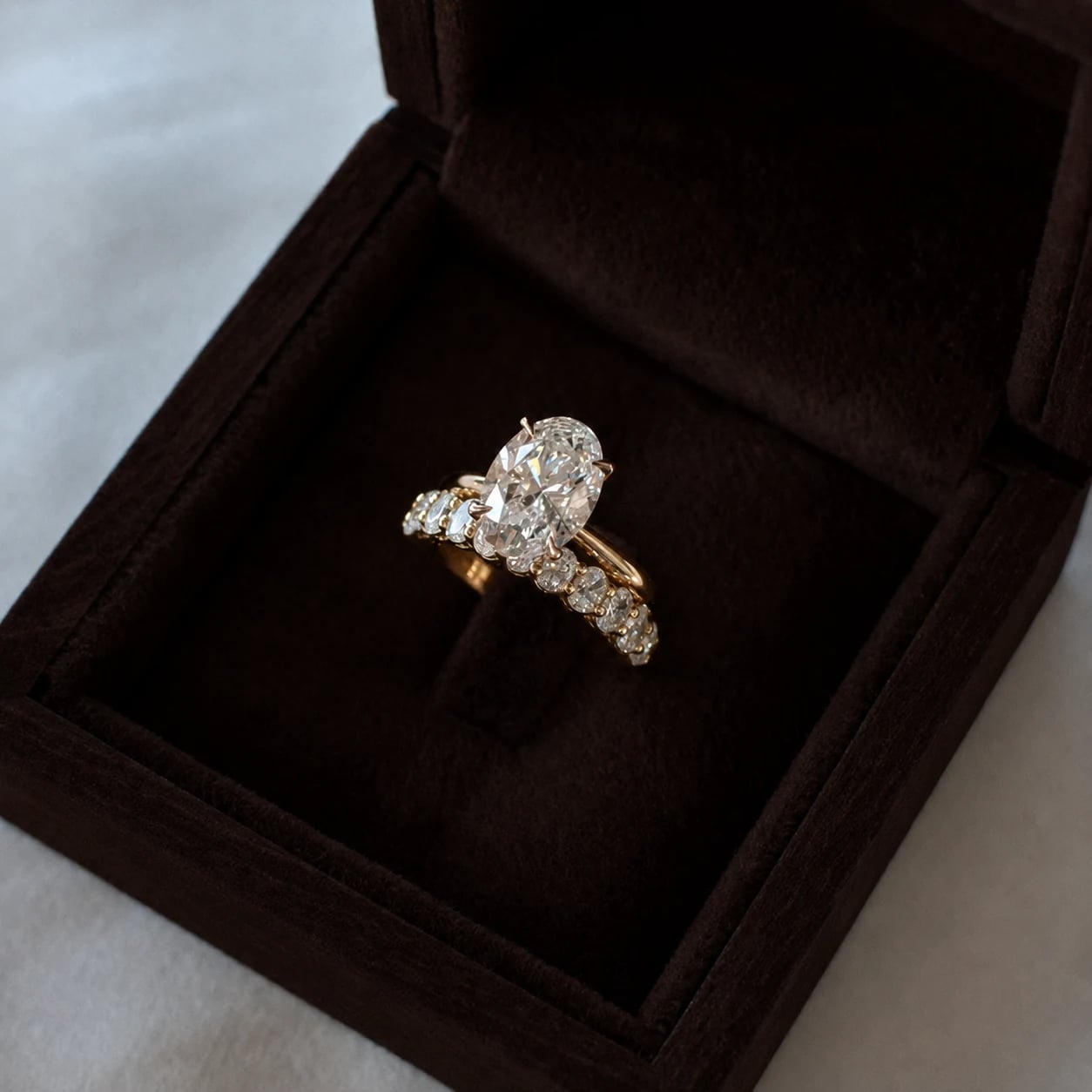 Oval lab-grown diamond engagement ring and matching band in a Lily Dia ring box