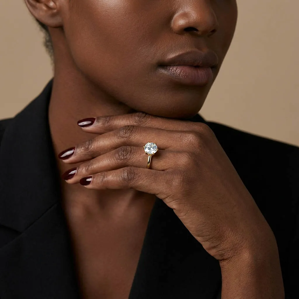 Round brilliant lab-grown diamond engagement ring worn on the ring finger of the left hand